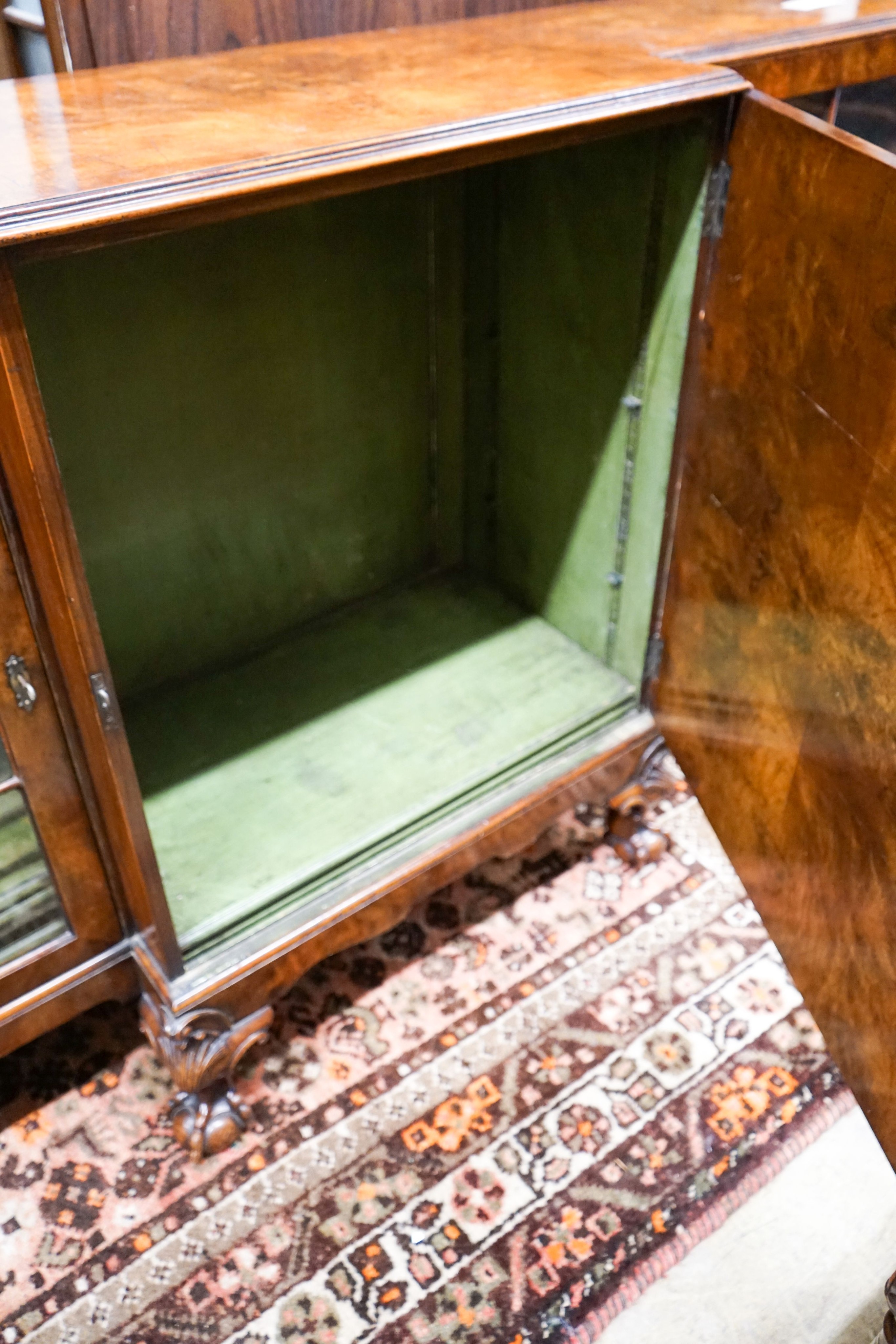 A Queen Anne revival figured walnut breakfront bookcase